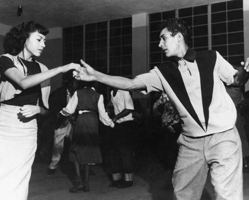 Teenagers dance together at an event at the William Mead Homes Housing Project in Chinatown, Los Angeles, CA. Los Angeles Public Library Photo Collection.