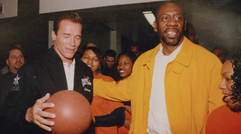 Gil Walker (right), who brought in Arnold Schwarzenegger and other celebrities to ceremonies held for his Chicago league, knew the value of adding some glitz to Midnight Basketball. Dot Wart/Courtesy of Gil Walker.