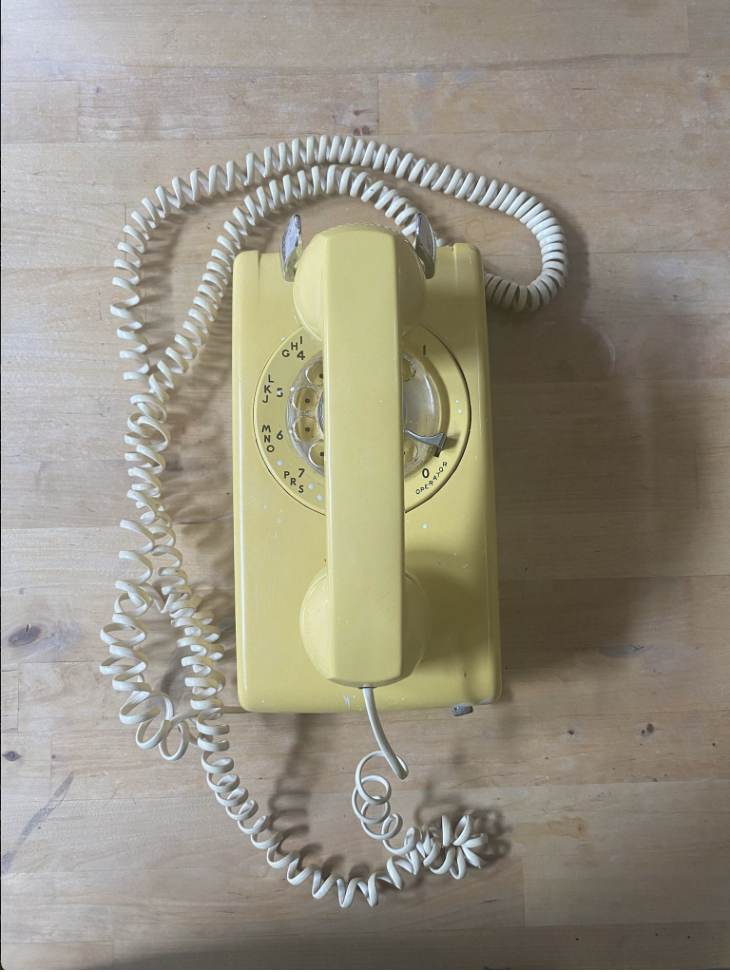 Yellow landline telephone centered and taken from above