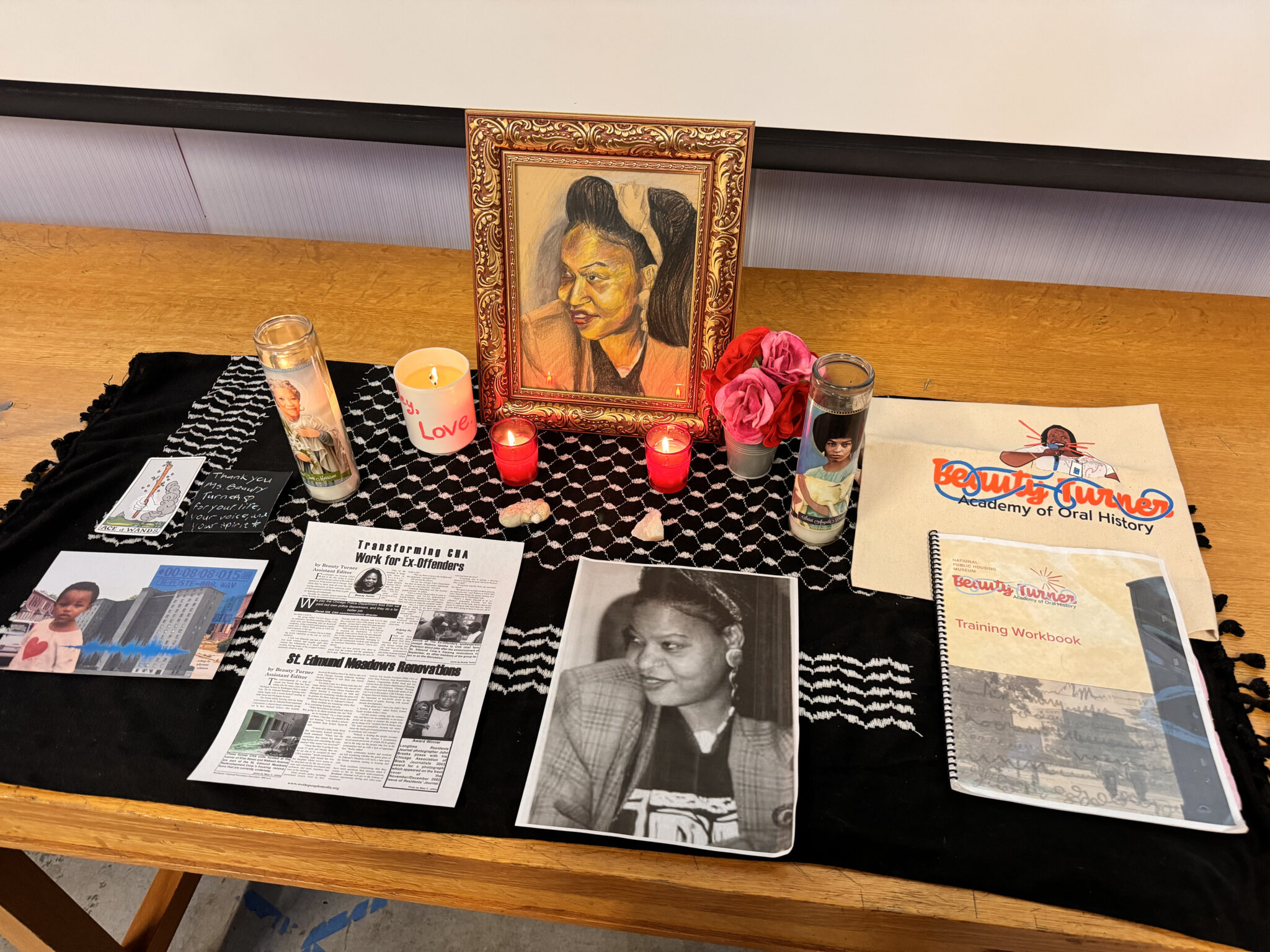 An altar created for the 2024 memorial birthday celebration of Ms. Beauty Turner. The altar features candles, felt flowers, a printed photo from Ms. Beauty’s blog, a hand-drawn version of the same photo, and other offerings from the NPHM’s Beauty Turner Academy programming.