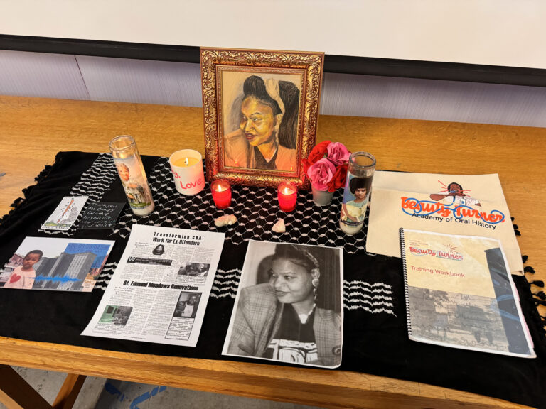 An altar created for the 2024 memorial birthday celebration of Ms. Beauty Turner. The altar features candles, felt flowers, a printed photo from Ms. Beauty’s blog, a hand-drawn version of the same photo, and other offerings from the NPHM’s Beauty Turner Academy programming.