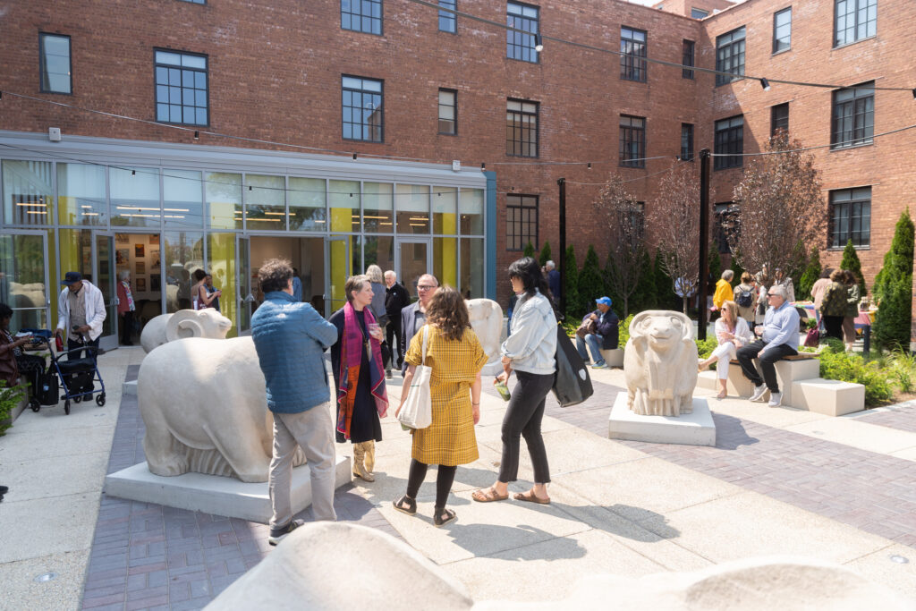 People mingle outdoors in a courtyard
