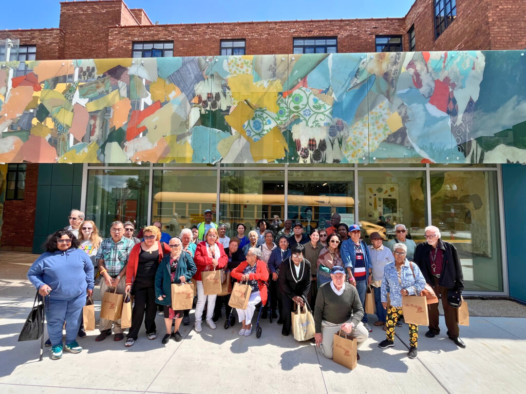 A group of seniors outside of the National Public Housing Museum