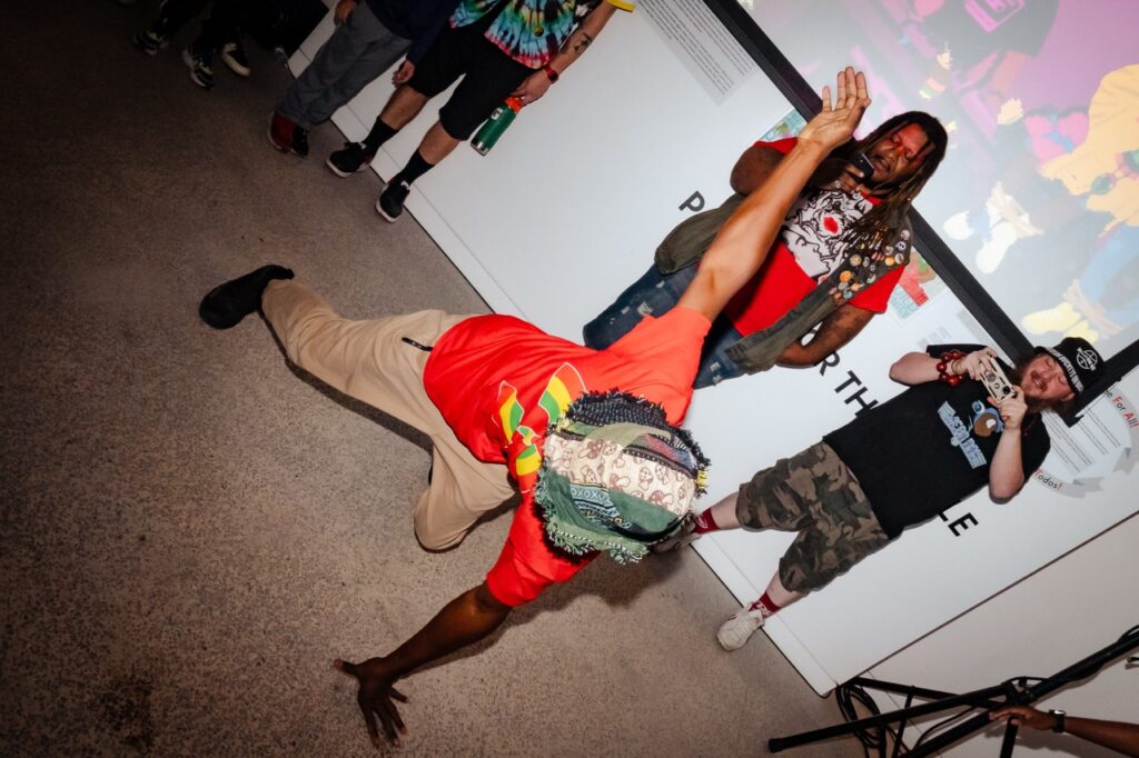 A person in a red shirt break dances