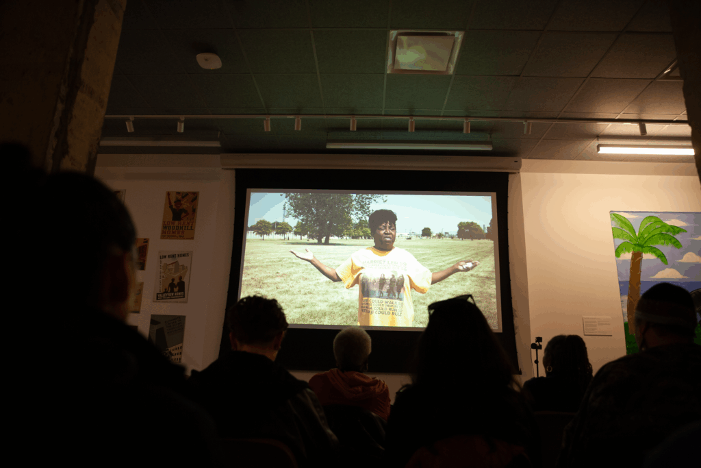An audience watching a film projected on a screen