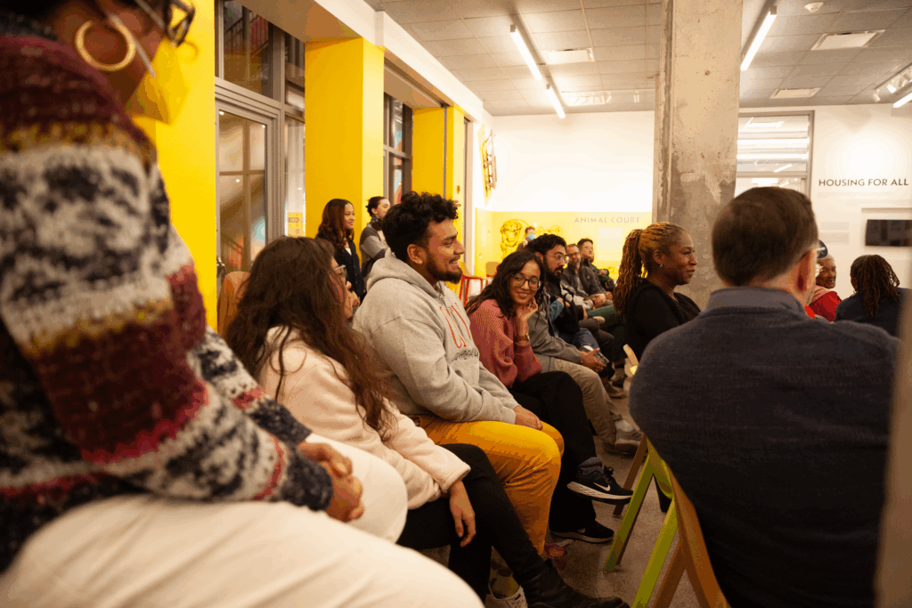 An audience gathers for a film screening at a museum