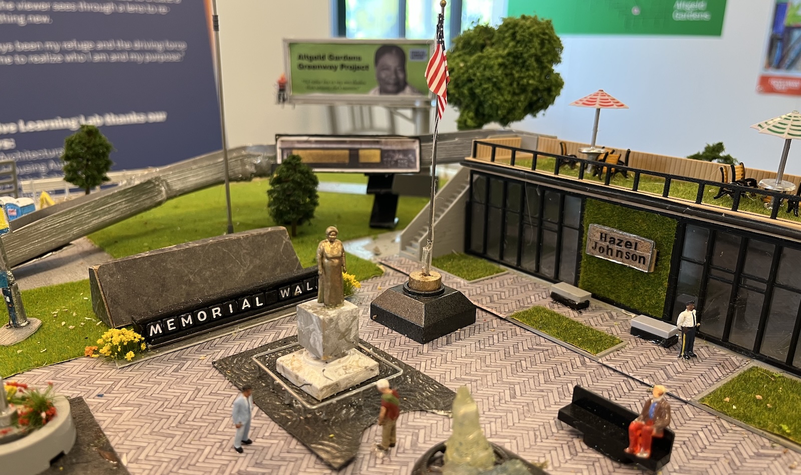 A diorama on display in a museum shows a green space and memorial to Hazel Johnson