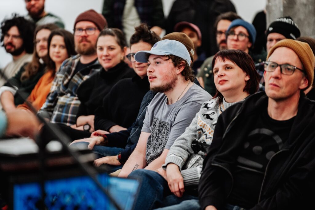 A diverse crowd listens during a concert