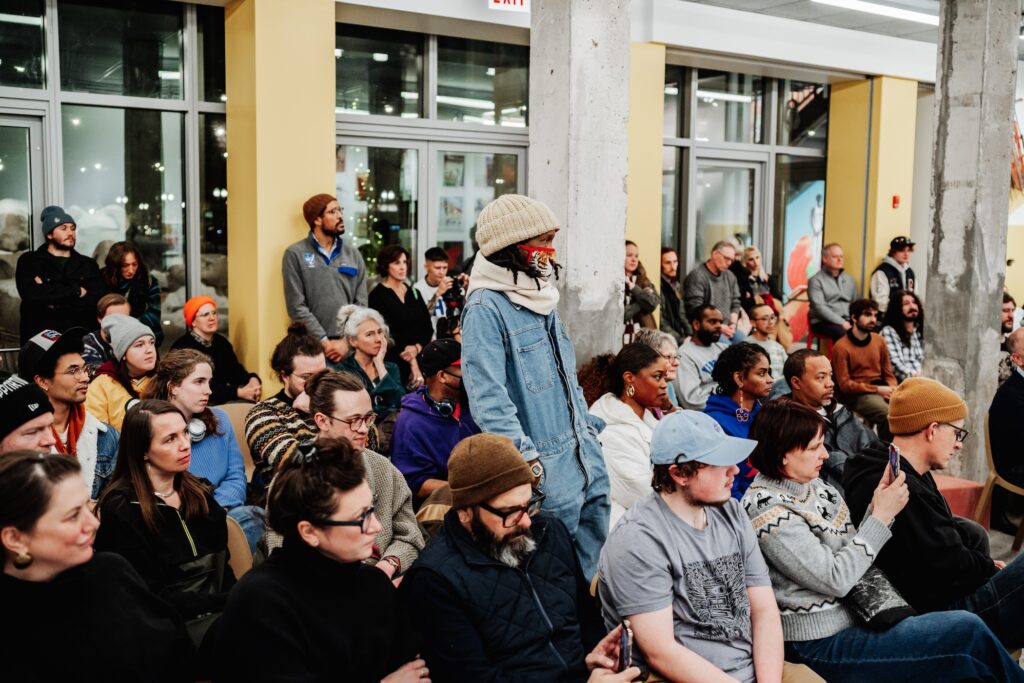 A diverse crowd packed in the museum for a concert