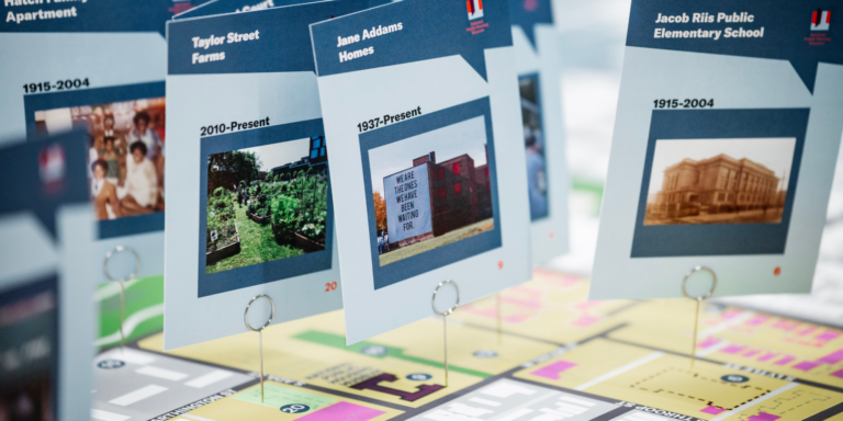 Cards with photos of places and dates are set on top of a map of a neighborhood