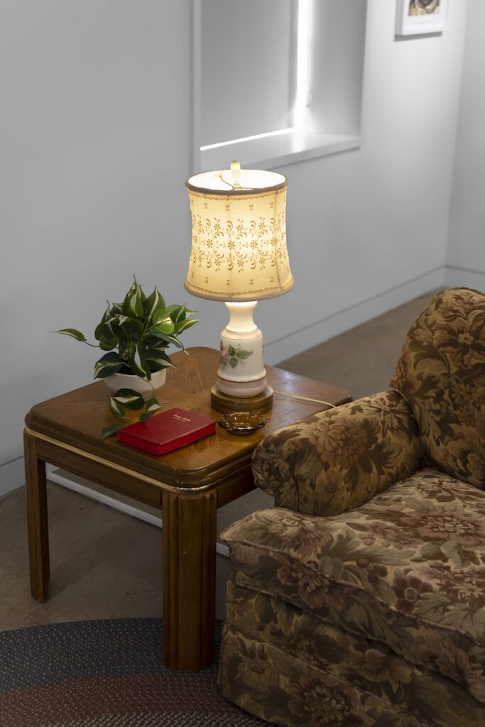 A vignette of a vintage 90s living room recreated in a gallery
