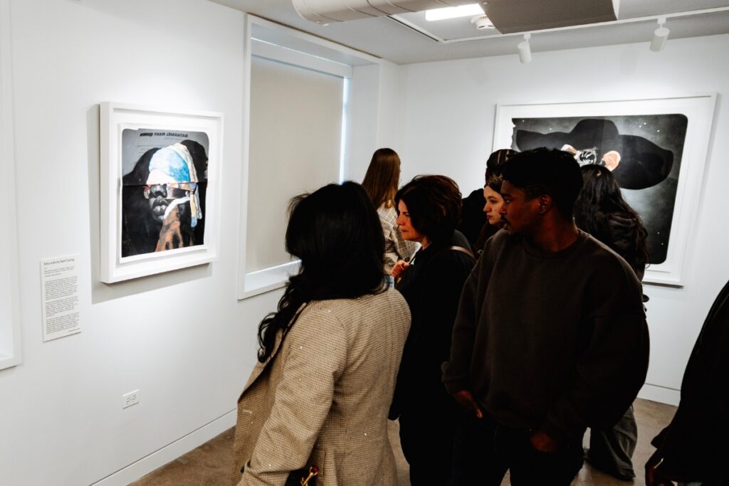 A group of visitors look at art in a gallery