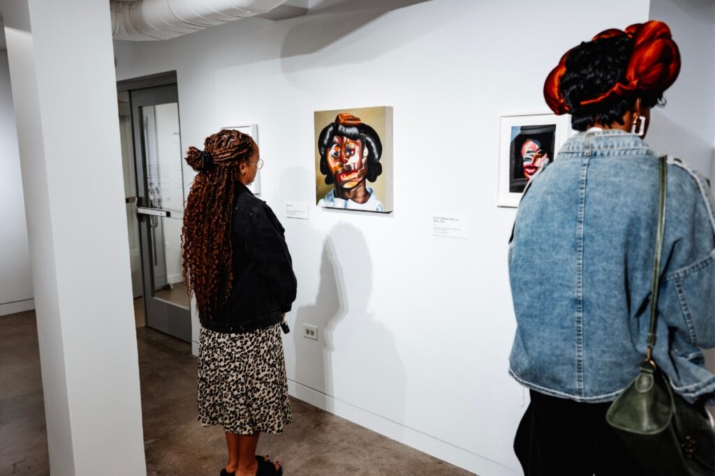People looking at portraits in a gallery