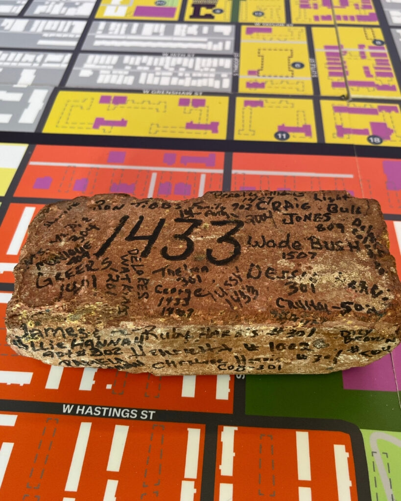 A brick with signatures and the number 1433
