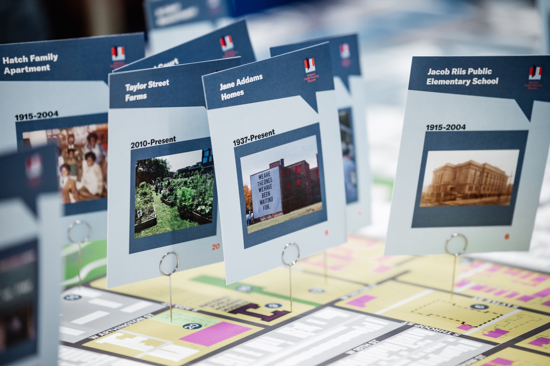 A close up view of a tabletop map with pinned locations showing historic sites